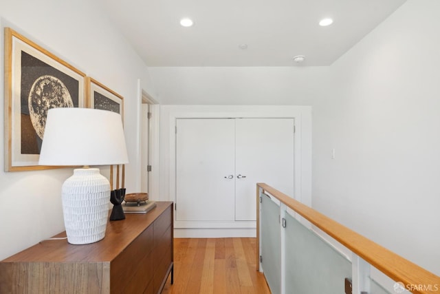 hallway featuring light wood finished floors and recessed lighting