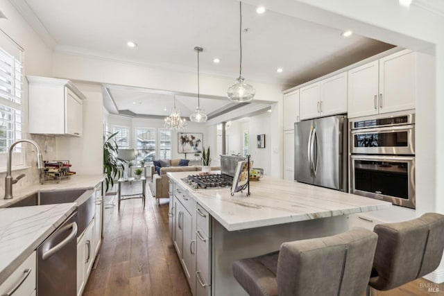 110 Baypoint Dr, San Rafael, CA 94901 - kitchen featuring stainless steel appliances, open floor plan, a sink, crown molding, and light stone counters