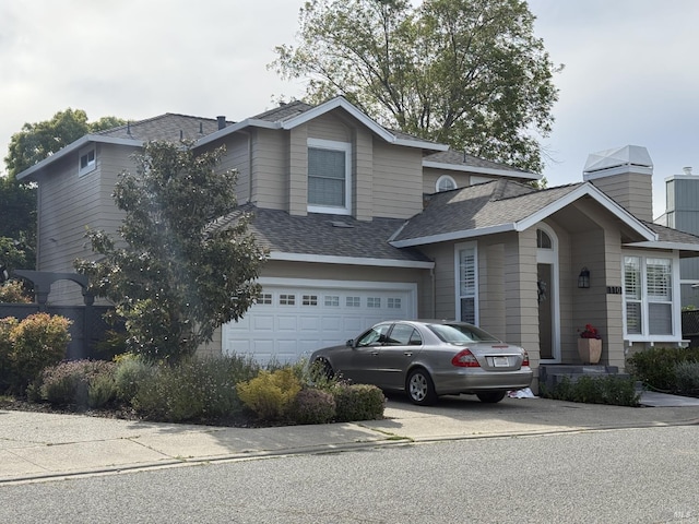 view of front of property with an attached garage, roof with shingles, a chimney, and driveway