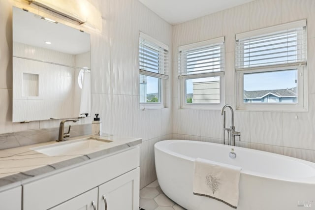 110 Baypoint Dr, San Rafael, CA 94901 - bathroom featuring a freestanding tub, vanity, tile patterned flooring, and tile walls