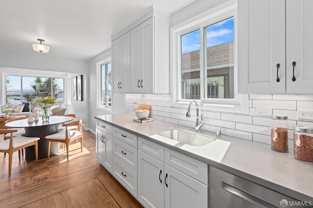 939 Innes Ave, San Francisco, CA 94124 - kitchen featuring dishwasher, light countertops, decorative backsplash, and dark wood finished floors