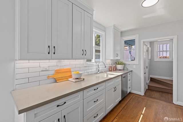 939 Innes Ave, San Francisco, CA 94124 - kitchen with dark wood finished floors, tasteful backsplash, dishwasher, and healthy amount of natural light