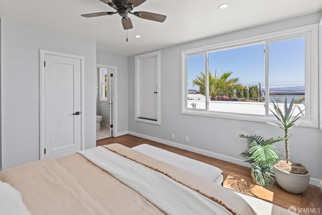 939 Innes Ave, San Francisco, CA 94124 - bedroom with multiple windows, recessed lighting, wood finished floors, ensuite bath, and a ceiling fan