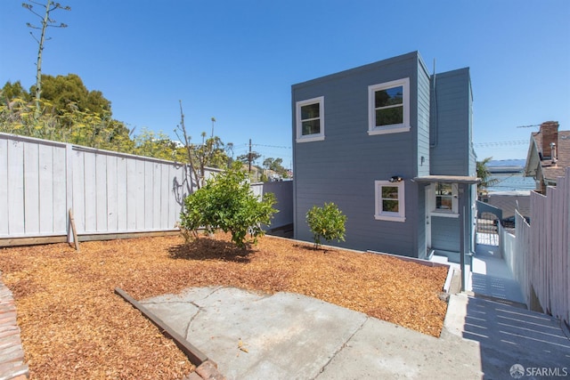 939 Innes Ave, San Francisco, CA 94124 - view of side of property featuring a fenced backyard, a patio, and a gate
