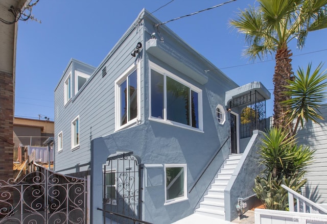 939 Innes Ave, San Francisco, CA 94124 - view of property exterior featuring stucco siding and stairway