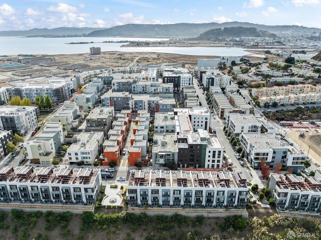 drone / aerial view featuring a water and mountain view