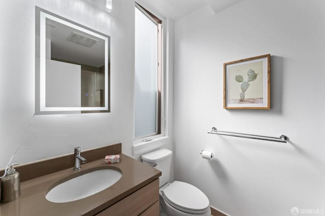 bathroom with toilet and vanity