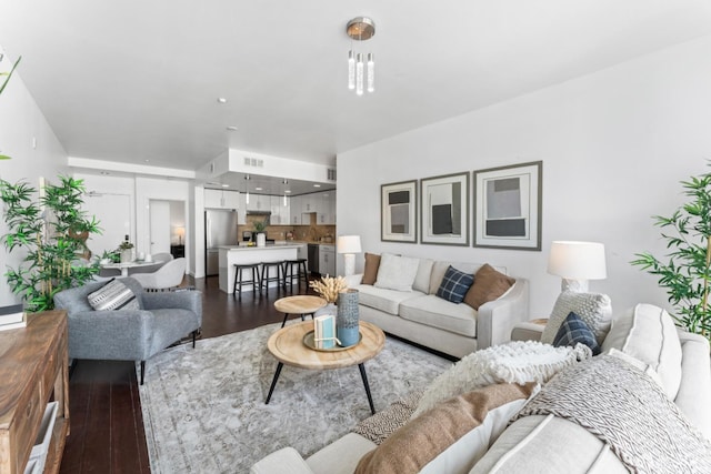 living room with dark wood-type flooring and visible vents