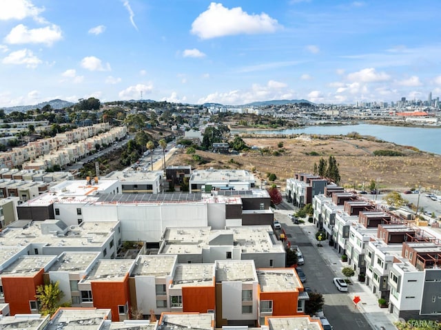 drone / aerial view featuring a city view and a water view