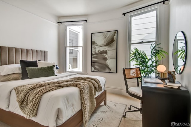 bedroom featuring light colored carpet