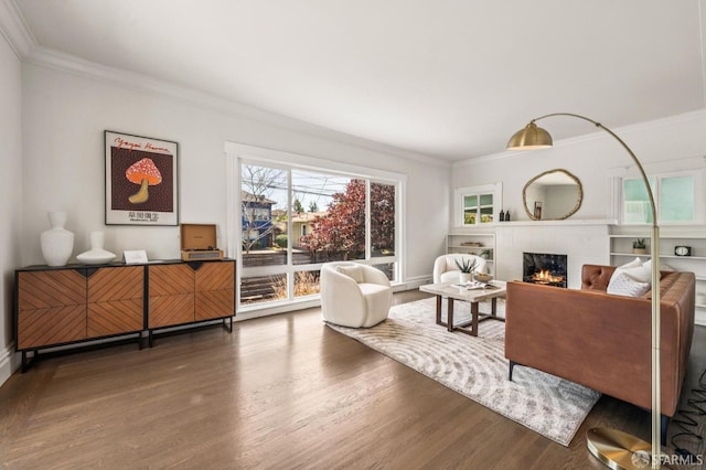 882 56th St, Oakland, CA 94608 - living area with wood finished floors, ornamental molding, and a lit fireplace