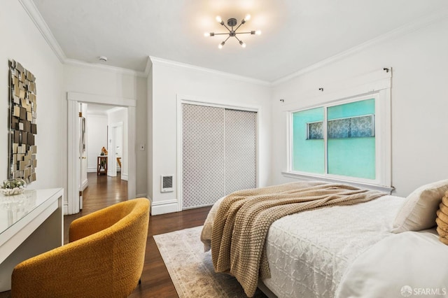 882 56th St, Oakland, CA 94608 - bedroom with a chandelier, dark wood finished floors, ornamental molding, and a closet