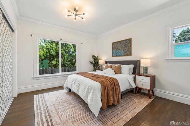 882 56th St, Oakland, CA 94608 - bedroom featuring multiple windows, wood finished floors, ornamental molding, and a chandelier