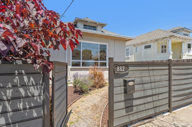 882 56th St, Oakland, CA 94608 - view of front of house featuring stucco siding and a shingled roof