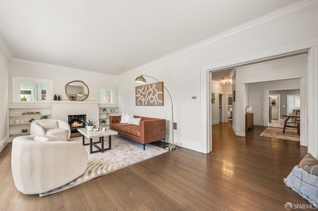 882 56th St, Oakland, CA 94608 - living area with ornamental molding, dark wood-style floors, healthy amount of natural light, and a brick fireplace
