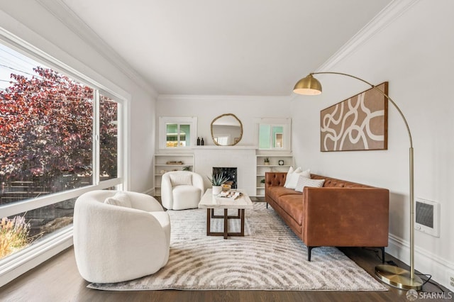 882 56th St, Oakland, CA 94608 - living area featuring wood finished floors, crown molding, a brick fireplace, and heating unit