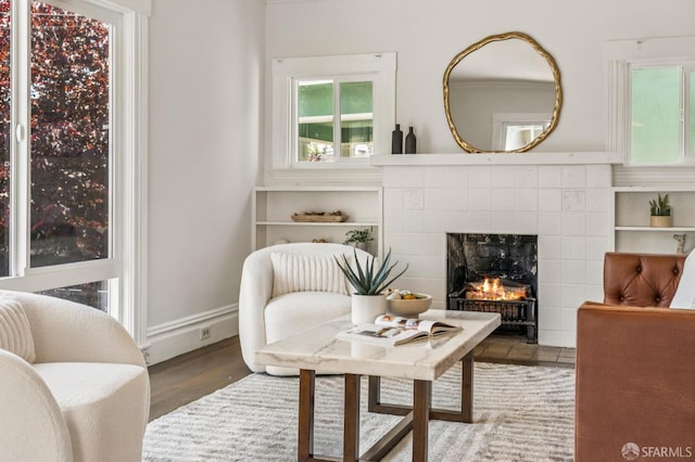 882 56th St, Oakland, CA 94608 - living room featuring a fireplace and wood finished floors