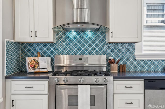 882 56th St, Oakland, CA 94608 - kitchen featuring appliances with stainless steel finishes, wall chimney exhaust hood, dark countertops, and white cabinetry