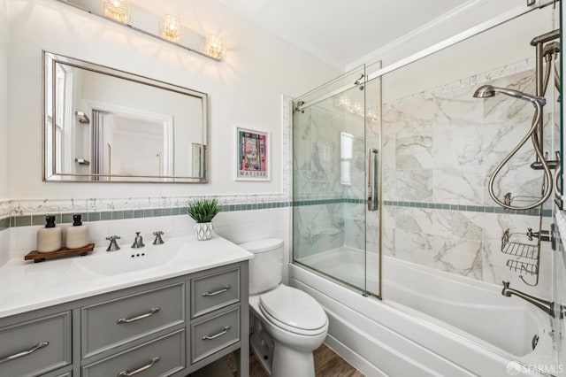 882 56th St, Oakland, CA 94608 - full bath featuring vanity, shower / bath combination with glass door, tile walls, and wainscoting