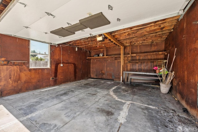 882 56th St, Oakland, CA 94608 - garage with wooden walls and a garage door opener