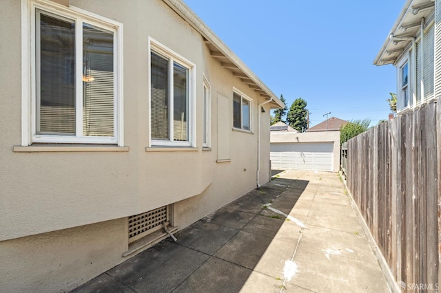882 56th St, Oakland, CA 94608 - view of side of home featuring stucco siding and a patio area