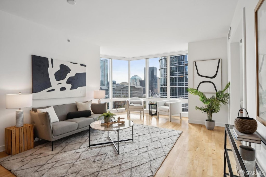 living room featuring expansive windows and light wood-type flooring