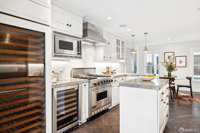 kitchen featuring stainless steel appliances, white cabinetry, wall chimney range hood, and wine cooler