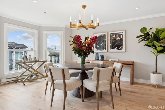 dining area featuring an inviting chandelier, ornamental molding, and light hardwood / wood-style floors