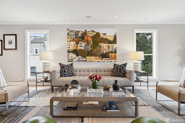 living room with crown molding and light hardwood / wood-style floors