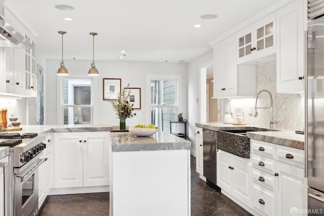 kitchen with sink, white cabinetry, decorative light fixtures, high quality appliances, and decorative backsplash