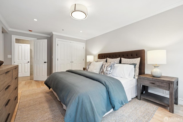 bedroom with crown molding, light hardwood / wood-style floors, and a closet