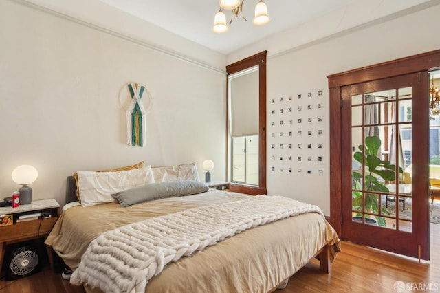522 Liberty St, San Francisco, CA 94114 - bedroom featuring multiple windows, wood finished floors, and a chandelier