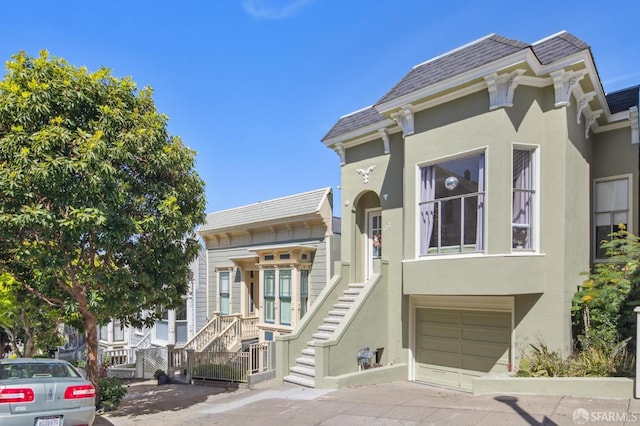 522 Liberty St, San Francisco, CA 94114 - townhome / multi-family property featuring stucco siding, stairway, concrete driveway, and an attached garage