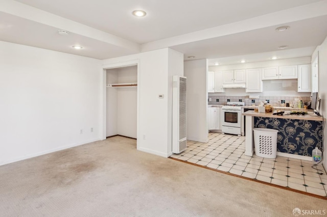 522 Liberty St, San Francisco, CA 94114 - kitchen with white cabinets, light carpet, white gas stove, and recessed lighting