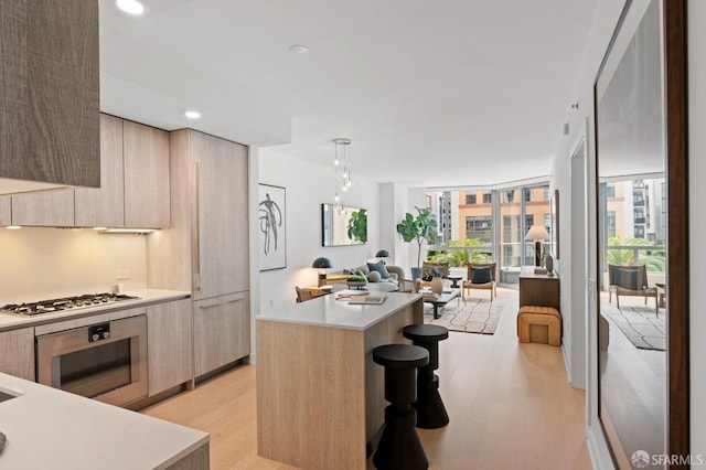 333 Beale St Unit 5I, San Francisco, CA 94105 - kitchen featuring modern cabinets, stainless steel appliances, light wood-style flooring, open floor plan, and recessed lighting