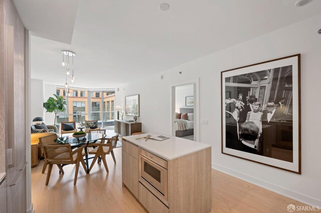 333 Beale St Unit 5I, San Francisco, CA 94105 - kitchen featuring light brown cabinetry, modern cabinets, light wood finished floors, light countertops, and open floor plan