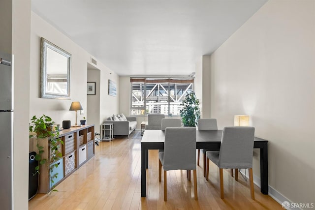 dining space with light wood-type flooring