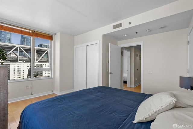 bedroom featuring light hardwood / wood-style floors and a closet