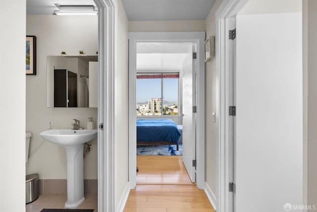 bathroom with hardwood / wood-style floors