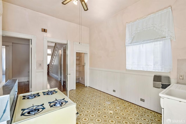 1075 Noe St, San Francisco, CA 94114 - kitchen with light countertops, ceiling fan, and wainscoting