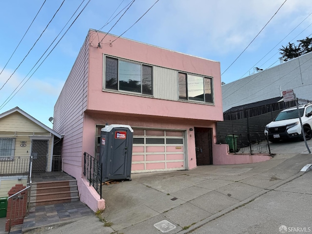 18 Prague St, San Francisco, CA 94112 - view of front of home with driveway, stucco siding, and an attached garage
