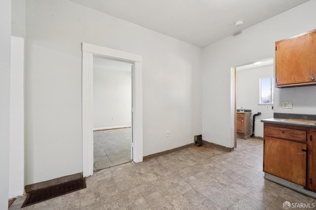 unfurnished dining area with baseboards