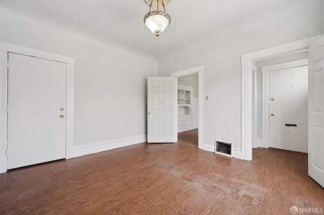 interior space featuring baseboards and wood finished floors