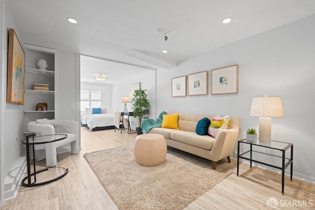 living area featuring wood finished floors and recessed lighting