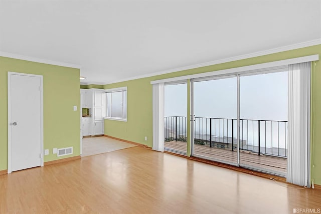 unfurnished room featuring crown molding and light hardwood / wood-style floors