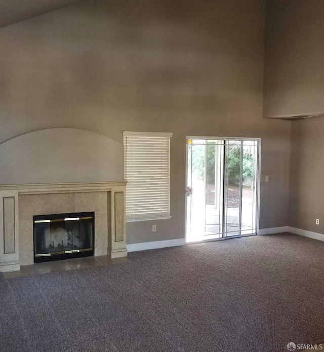4400 Elk Dr, Antioch, CA 94531 - unfurnished living room featuring carpet flooring, baseboards, a tile fireplace, and a high ceiling