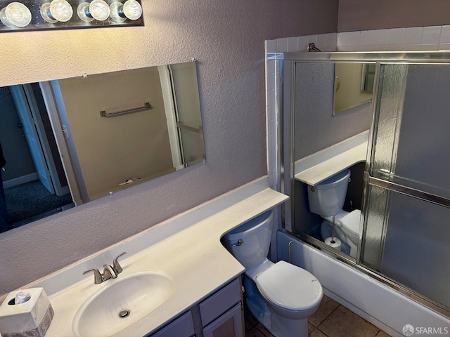 4400 Elk Dr, Antioch, CA 94531 - bathroom featuring toilet, vanity, a textured wall, tile patterned floors, and bath / shower combo with glass door