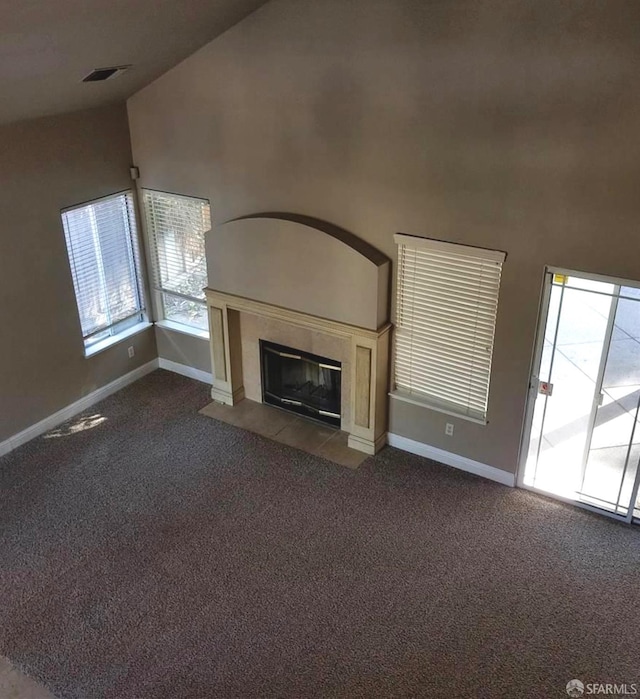 4400 Elk Dr, Antioch, CA 94531 - unfurnished living room with dark carpet, high vaulted ceiling, a tiled fireplace, and baseboards
