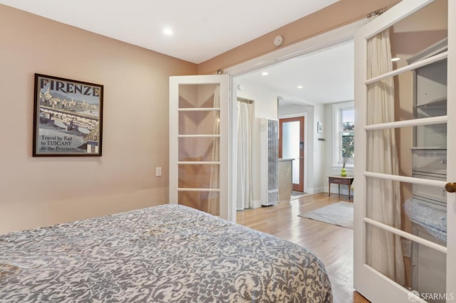 bedroom featuring recessed lighting and wood finished floors