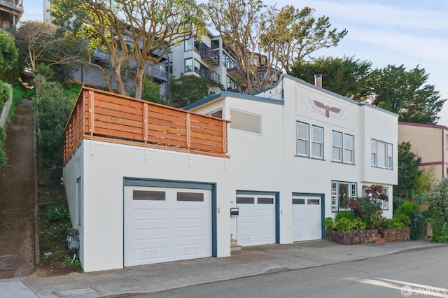 exterior space with an attached garage, driveway, and stucco siding